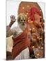 Holy Man in Front of a Ganesh Statue Draped in Fairy Lights at the Hindu Festival of Shivaratri-Don Smith-Mounted Photographic Print