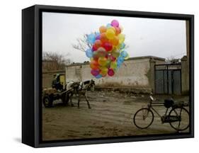 Horse Drawn Cart Drives Past as Balloons Tied to a Bicycle Flutter in the Wind-null-Framed Stretched Canvas