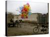 Horse Drawn Cart Drives Past as Balloons Tied to a Bicycle Flutter in the Wind-null-Stretched Canvas