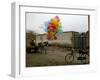 Horse Drawn Cart Drives Past as Balloons Tied to a Bicycle Flutter in the Wind-null-Framed Photographic Print