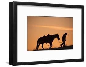 Horse drive in winter, Shell, Wyoming. Cowboy leading his horse at sunset and silhouetted.-Darrell Gulin-Framed Photographic Print