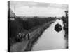 Horse Pulls a Barge Full of Coal Along the Canal Towpath-null-Stretched Canvas