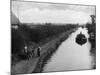 Horse Pulls a Barge Full of Coal Along the Canal Towpath-null-Mounted Photographic Print