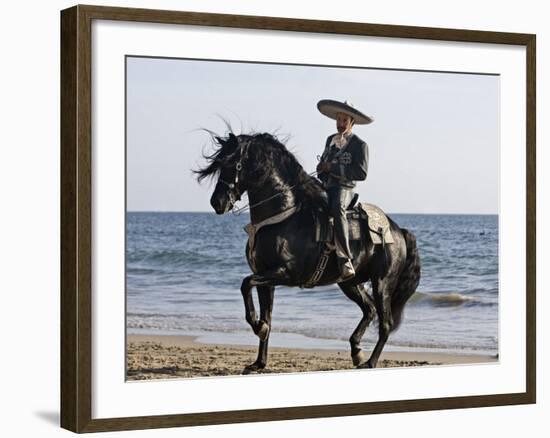 Horseman in Traditional Dress Riding Black Andalusian Stallion on Beach, Ojai, California, USA-Carol Walker-Framed Photographic Print