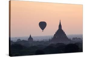 Hot Air Balloon over Temples on a Misty Morning at Dawn, Bagan (Pagan), Myanmar (Burma)-Stephen Studd-Stretched Canvas