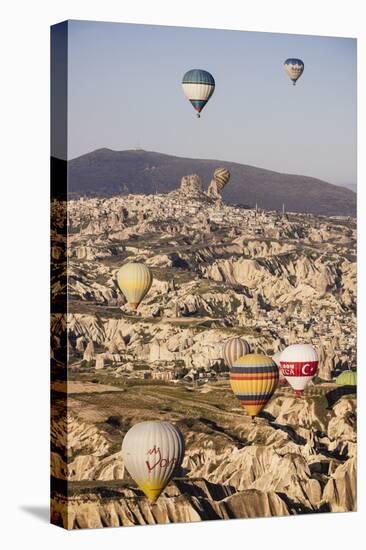 Hot Air Balloons Flying Among Rock Formations at Sunrise in the Red Valley-Ben Pipe-Stretched Canvas