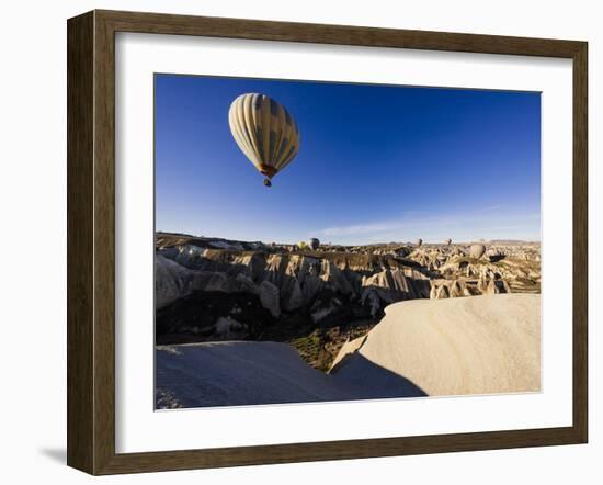 Hot Air Balloons Flying Among Rock Formations at Sunrise in the Red Valley-Ben Pipe-Framed Photographic Print