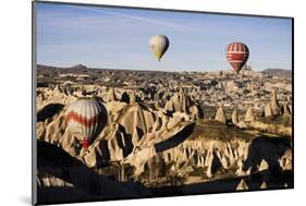 Hot Air Balloons Flying Among Rock Formations at Sunrise in the Red Valley-Ben Pipe-Mounted Photographic Print