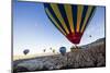 Hot Air Balloons Flying Among Rock Formations at Sunrise in the Red Valley-Ben Pipe-Mounted Photographic Print