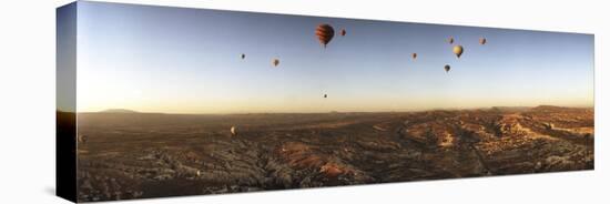 Hot Air Balloons over Landscape at Sunrise, Cappadocia, Central Anatolia Region, Turkey-null-Stretched Canvas