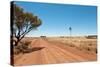 Hot Dusty Road across Flat Landscape with Water Vane-Will Wilkinson-Stretched Canvas