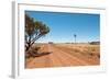 Hot Dusty Road across Flat Landscape with Water Vane-Will Wilkinson-Framed Photographic Print