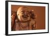 Hotei or the Laughing Buddha is a Wooden Statue on a Brown Background..-null-Framed Photographic Print