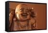 Hotei or the Laughing Buddha is a Wooden Statue on a Brown Background..-null-Framed Stretched Canvas