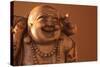 Hotei or the Laughing Buddha is a Wooden Statue on a Brown Background..-null-Stretched Canvas