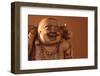 Hotei or the Laughing Buddha is a Wooden Statue on a Brown Background..-null-Framed Photographic Print