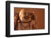 Hotei or the Laughing Buddha is a Wooden Statue on a Brown Background..-null-Framed Photographic Print