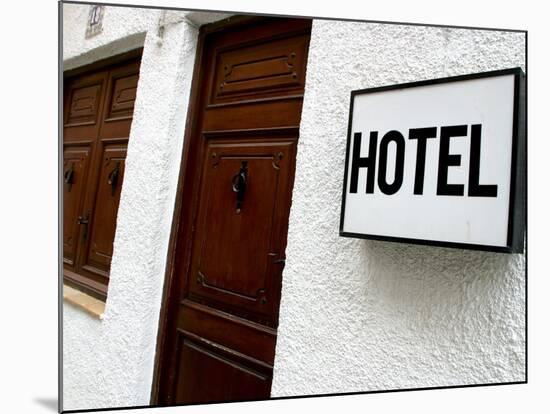 Hotel Sign on a Wall Near a Door-null-Mounted Photographic Print