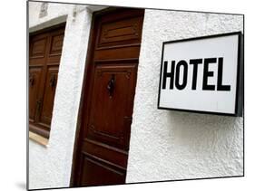 Hotel Sign on a Wall Near a Door-null-Mounted Photographic Print