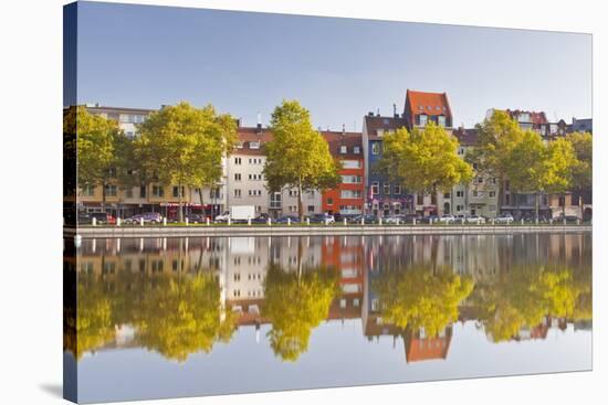 Houses and Shops Reflecting in a Pond, Cologne, North Rhine-Westphalia, Germany, Europe-Julian Elliott-Stretched Canvas