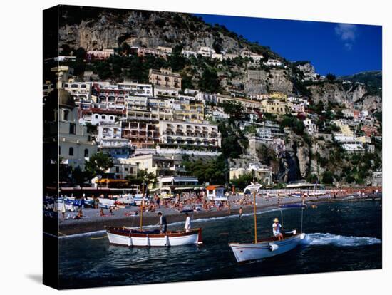 Houses Terraced into Rugged Amalfi Coastline, Boats in Foreground, Positano, Italy-Dallas Stribley-Stretched Canvas