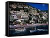 Houses Terraced into Rugged Amalfi Coastline, Boats in Foreground, Positano, Italy-Dallas Stribley-Framed Stretched Canvas