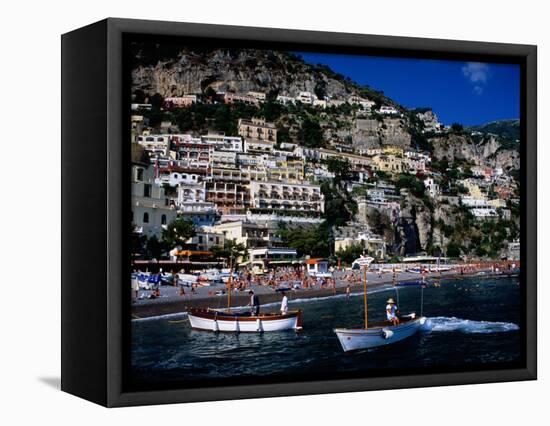 Houses Terraced into Rugged Amalfi Coastline, Boats in Foreground, Positano, Italy-Dallas Stribley-Framed Stretched Canvas