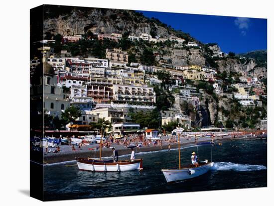 Houses Terraced into Rugged Amalfi Coastline, Boats in Foreground, Positano, Italy-Dallas Stribley-Stretched Canvas