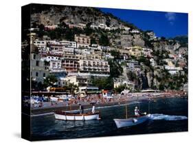 Houses Terraced into Rugged Amalfi Coastline, Boats in Foreground, Positano, Italy-Dallas Stribley-Stretched Canvas