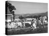 Housewife in Tygart Valley Removing Laundry from Clothesline, Her Young Daughter Stands Beside Her-Carl Mydans-Stretched Canvas