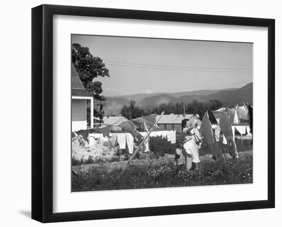 Housewife in Tygart Valley Removing Laundry from Clothesline, Her Young Daughter Stands Beside Her-Carl Mydans-Framed Photographic Print