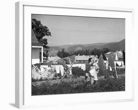 Housewife in Tygart Valley Removing Laundry from Clothesline, Her Young Daughter Stands Beside Her-Carl Mydans-Framed Photographic Print