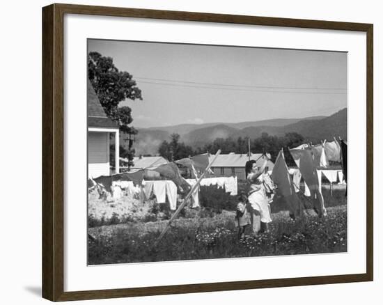 Housewife in Tygart Valley Removing Laundry from Clothesline, Her Young Daughter Stands Beside Her-Carl Mydans-Framed Photographic Print