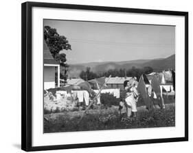 Housewife in Tygart Valley Removing Laundry from Clothesline, Her Young Daughter Stands Beside Her-Carl Mydans-Framed Photographic Print