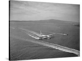 Howard Hughes' Spruce Goose Taxiing across Water-null-Stretched Canvas