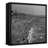 Huge Crowd Gathered in the Surf and at the Beach in Front of Coney Island Amusement Park-Marie Hansen-Framed Stretched Canvas