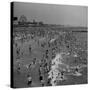 Huge Crowd Gathered in the Surf and at the Beach in Front of Coney Island Amusement Park-Marie Hansen-Stretched Canvas