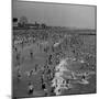 Huge Crowd Gathered in the Surf and at the Beach in Front of Coney Island Amusement Park-Marie Hansen-Mounted Premium Photographic Print