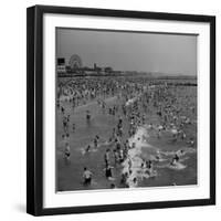 Huge Crowd Gathered in the Surf and at the Beach in Front of Coney Island Amusement Park-Marie Hansen-Framed Photographic Print