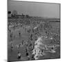 Huge Crowd Gathered in the Surf and at the Beach in Front of Coney Island Amusement Park-Marie Hansen-Mounted Photographic Print