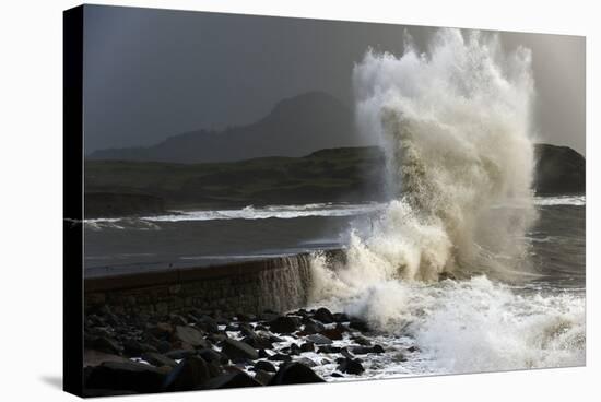 Huge Waves Crash Against a Stone Jetty at Criccieth, Gwynedd, Wales, United Kingdom, Europe-Graham Lawrence-Stretched Canvas