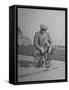 Humorous of Man Riding Tiny Bicycle-Wallace Kirkland-Framed Stretched Canvas