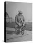 Humorous of Man Riding Tiny Bicycle-Wallace Kirkland-Stretched Canvas