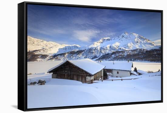 Huts and mountains covered in snow at sunset Spluga Maloja Canton of Graubunden Engadin Switzerland-ClickAlps-Framed Stretched Canvas