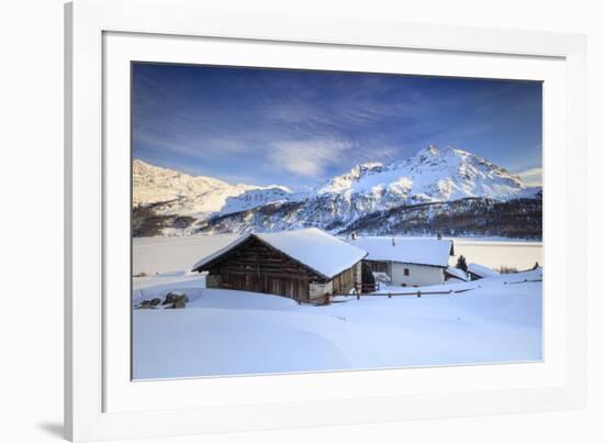 Huts and mountains covered in snow at sunset Spluga Maloja Canton of Graubunden Engadin Switzerland-ClickAlps-Framed Photographic Print