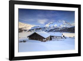 Huts and mountains covered in snow at sunset Spluga Maloja Canton of Graubunden Engadin Switzerland-ClickAlps-Framed Photographic Print