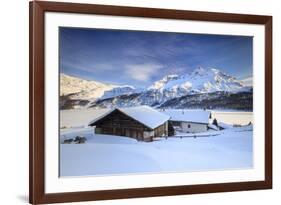 Huts and mountains covered in snow at sunset Spluga Maloja Canton of Graubunden Engadin Switzerland-ClickAlps-Framed Photographic Print