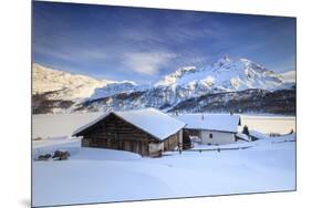 Huts and mountains covered in snow at sunset Spluga Maloja Canton of Graubunden Engadin Switzerland-ClickAlps-Mounted Photographic Print