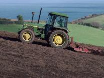 John Deere Tractor with a Rotivator on a Sloping Field in Spring, at Holcombe, Devon, England, UK-Ian Griffiths-Framed Photographic Print