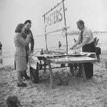 Girl Playing in the Sand while an Older Woman Gets Her Feet Wet in the Ocean at Blackpool Beach-Ian Smith-Photographic Print